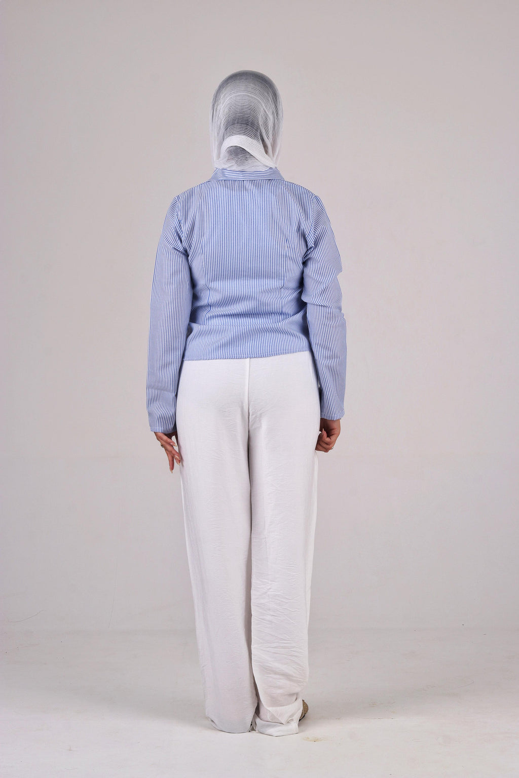 a light blue jacket and white pants