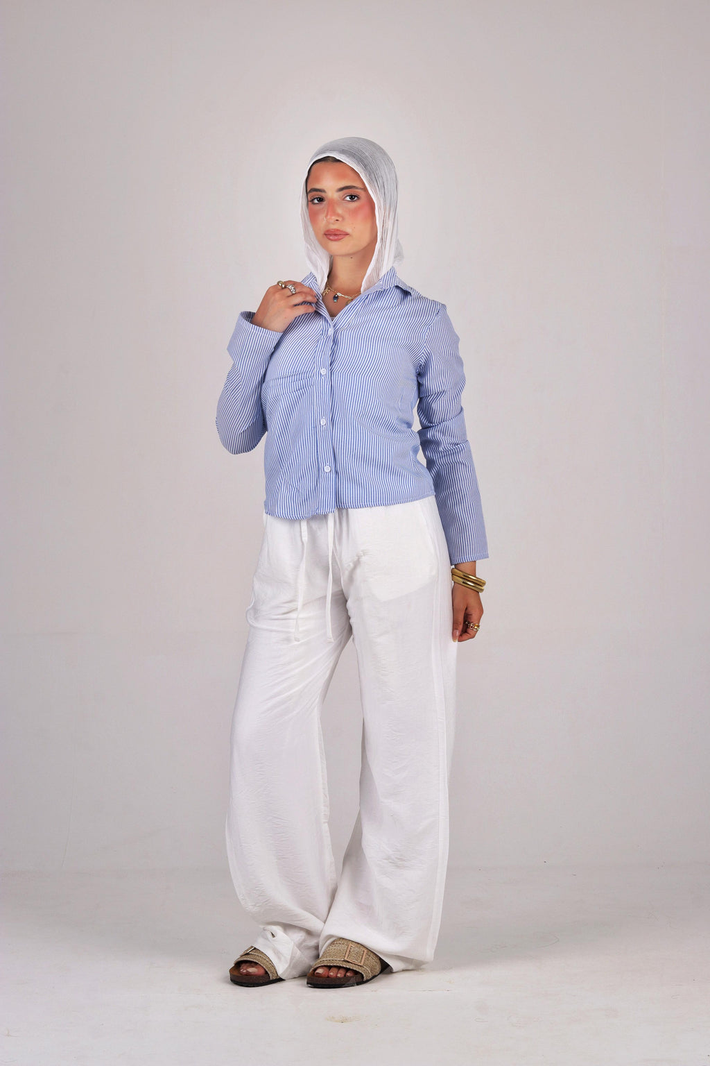 a light blue jacket and white pants 